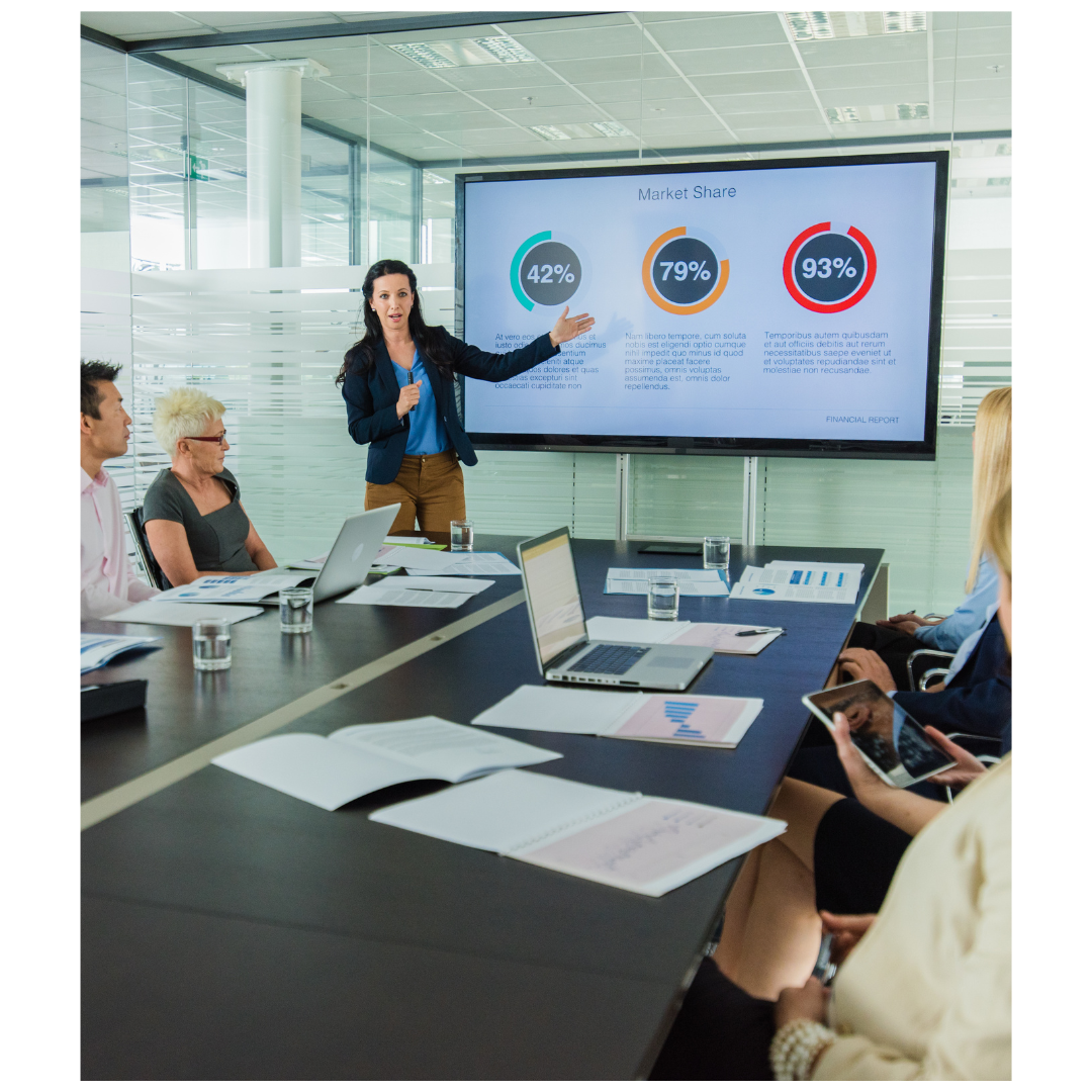 A woman giving a PowerPoint presentation to colleagues or clients.